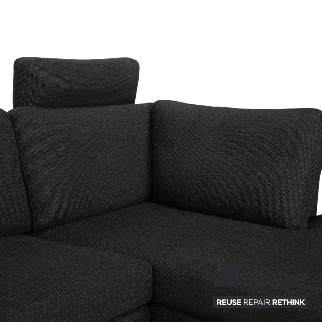 Canapé d'angle COR Conseta en tissu gris foncé avec pouf