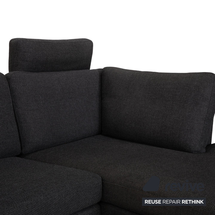 Canapé d'angle COR Conseta en tissu gris foncé avec pouf