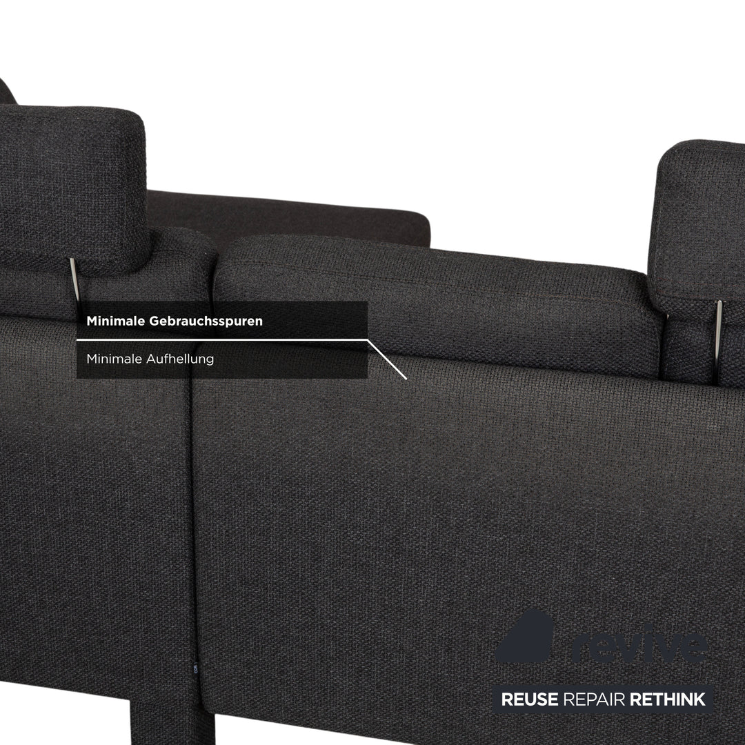 Canapé d'angle COR Conseta en tissu gris foncé avec pouf