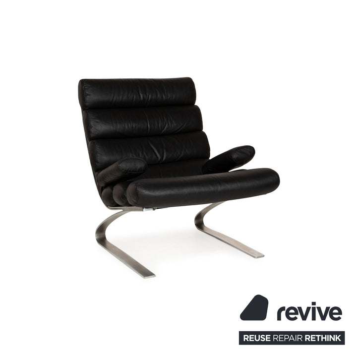 Fauteuil en cuir Cor Sinus noir avec tabouret